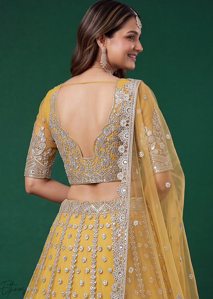 Mustard Yellow Heavy Floral Embroidered Net Lehenga